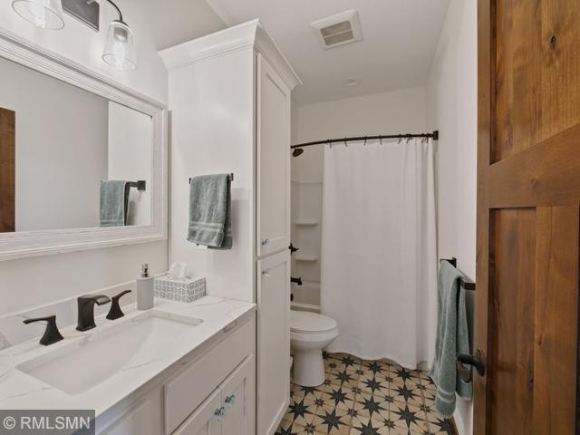 1706 57th Ave, Hammond, WI 54015 - bathroom with vanity, shower / bath combo, and tile patterned floors