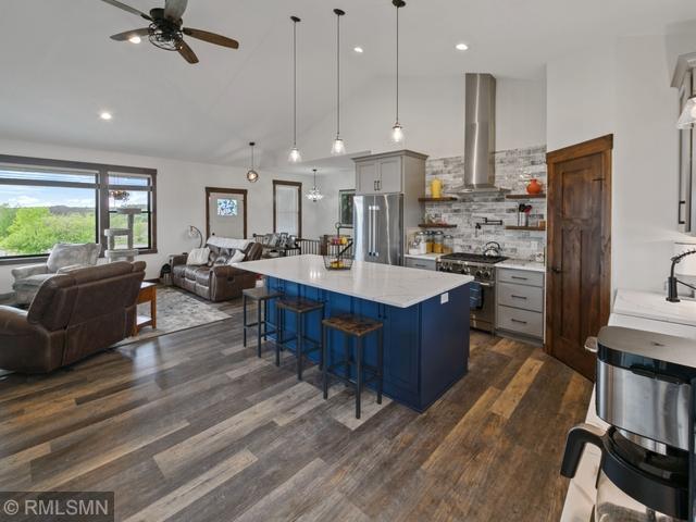 1706 57th Ave, Hammond, WI 54015 - kitchen featuring appliances with stainless steel finishes, open floor plan, extractor fan, a ceiling fan, and gray cabinetry