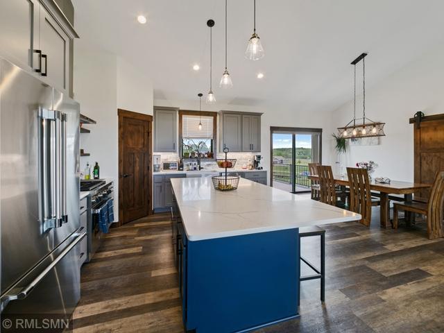 1706 57th Ave, Hammond, WI 54015 - kitchen with high end appliances, a center island, dark wood-style flooring, gray cabinetry, and lofted ceiling
