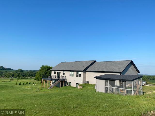 1706 57th Ave, Hammond, WI 54015 - back of house with stairway, a yard, and a wooden deck
