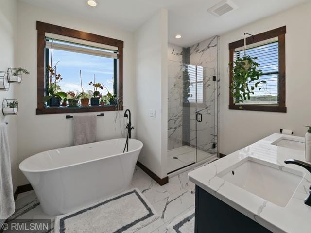 1706 57th Ave, Hammond, WI 54015 - bathroom featuring marble finish flooring, double vanity, a marble finish shower, healthy amount of natural light, and recessed lighting