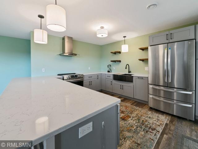 1706 57th Ave, Hammond, WI 54015 - kitchen with appliances with stainless steel finishes, wall chimney exhaust hood, gray cabinetry, and dark wood-type flooring