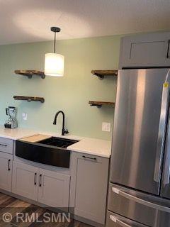 1706 57th Ave, Hammond, WI 54015 - kitchen with freestanding refrigerator, open shelves, light countertops, and gray cabinetry