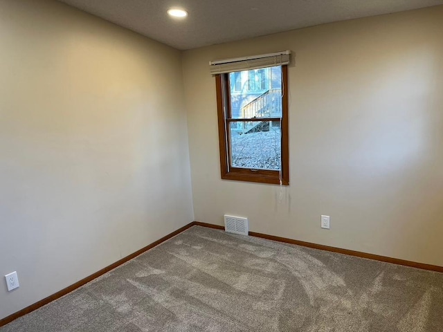 empty room with baseboards, carpet flooring, and recessed lighting
