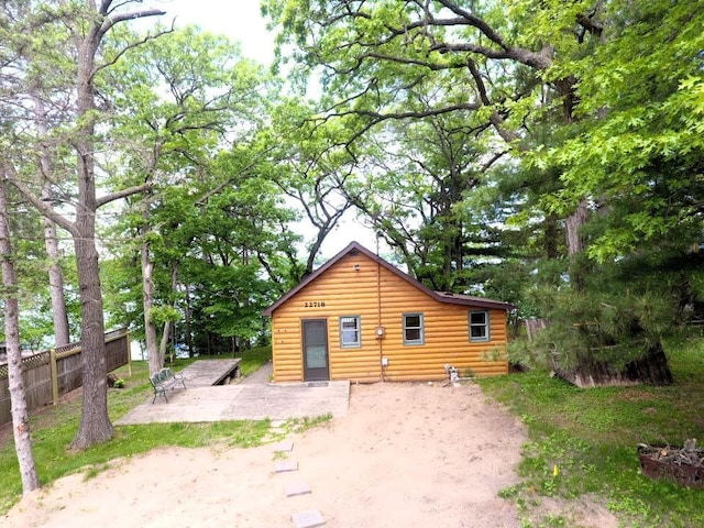 22718 Martin Lake Dr NE, Linwood Twp, MN 55092 - back of house featuring a patio and log veneer siding
