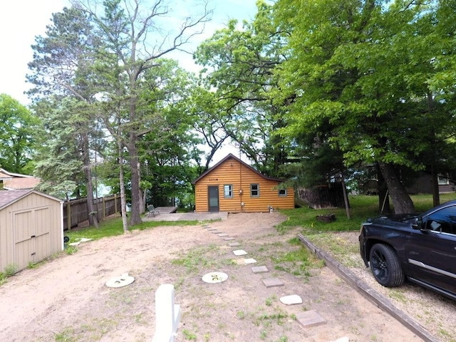 22718 Martin Lake Dr NE, Linwood Twp, MN 55092 - view of side of home with a storage unit and log veneer siding