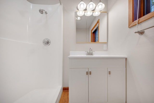 22718 Martin Lake Dr NE, Linwood Twp, MN 55092 - full bathroom featuring a shower, vanity, and wood finished floors