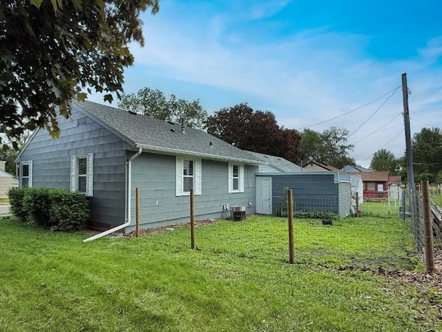 306 Blinkman St, Fairmont, MN 56031 - back of house with central AC and roof with shingles