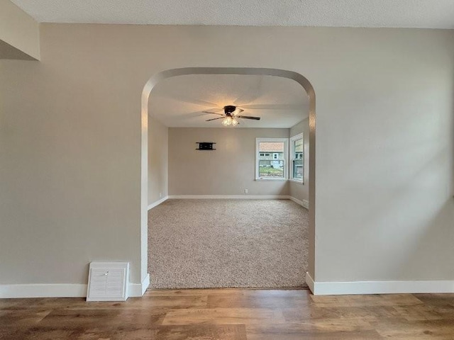306 Blinkman St, Fairmont, MN 56031 - unfurnished room with arched walkways, ceiling fan, baseboards, and carpet flooring