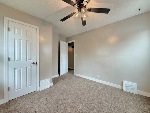 306 Blinkman St, Fairmont, MN 56031 - unfurnished bedroom featuring carpet flooring, baseboards, a textured ceiling, and ceiling fan