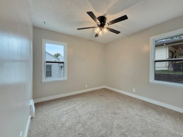 306 Blinkman St, Fairmont, MN 56031 - unfurnished room featuring carpet, baseboards, a ceiling fan, and a textured ceiling