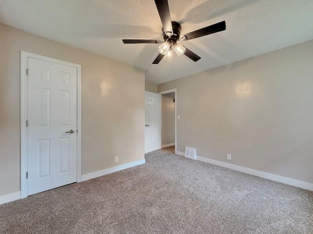 306 Blinkman St, Fairmont, MN 56031 - unfurnished bedroom featuring carpet floors, a textured ceiling, baseboards, and a ceiling fan