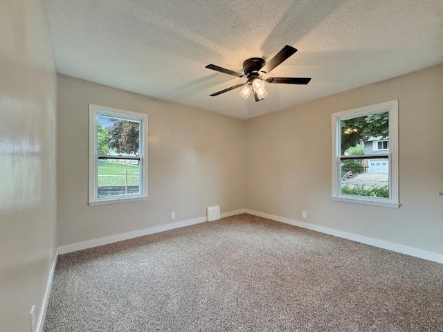 306 Blinkman St, Fairmont, MN 56031 - unfurnished room featuring a textured ceiling, a ceiling fan, carpet flooring, and baseboards