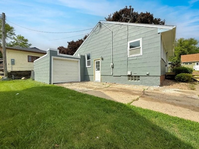 306 Blinkman St, Fairmont, MN 56031 - view of side of property with a lawn, a detached garage, and an outdoor structure