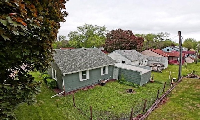 306 Blinkman St, Fairmont, MN 56031 - back of house with a shingled roof and an outbuilding