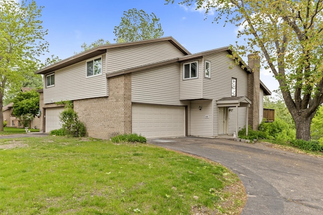 6007 Covington Ter, Minnetonka, MN 55345 - view of front facade featuring an attached garage, asphalt driveway, brick siding, a chimney, and a front lawn