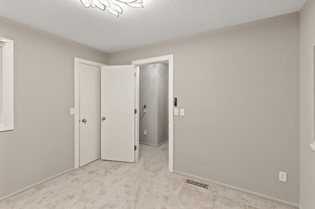 6007 Covington Ter, Minnetonka, MN 55345 - unfurnished bedroom featuring carpet, baseboards, and a textured ceiling