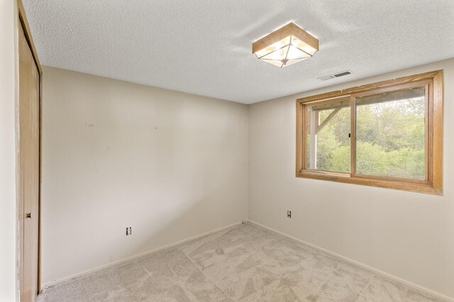 6007 Covington Ter, Minnetonka, MN 55345 - empty room featuring a textured ceiling, light carpet, and baseboards