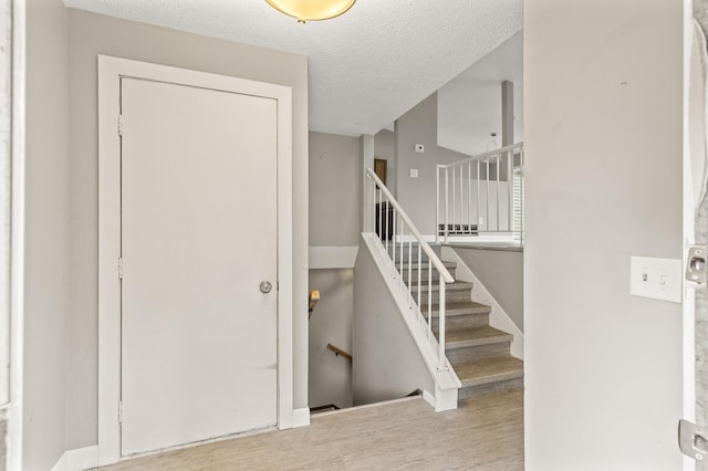 6007 Covington Ter, Minnetonka, MN 55345 - entryway featuring wood finished floors and a textured ceiling