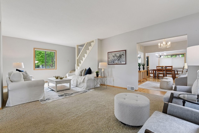 2452 Black Lake Rd, Spring Park, MN 55384 - carpeted living area featuring a chandelier, stairway, and baseboards