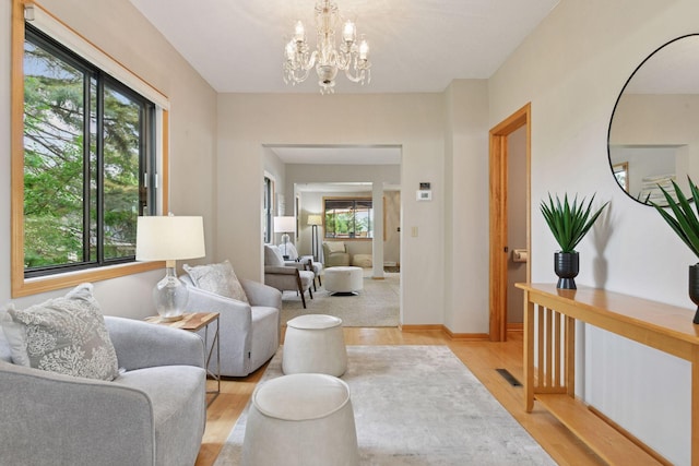2452 Black Lake Rd, Spring Park, MN 55384 - living room with light wood-style floors, a chandelier, and baseboards