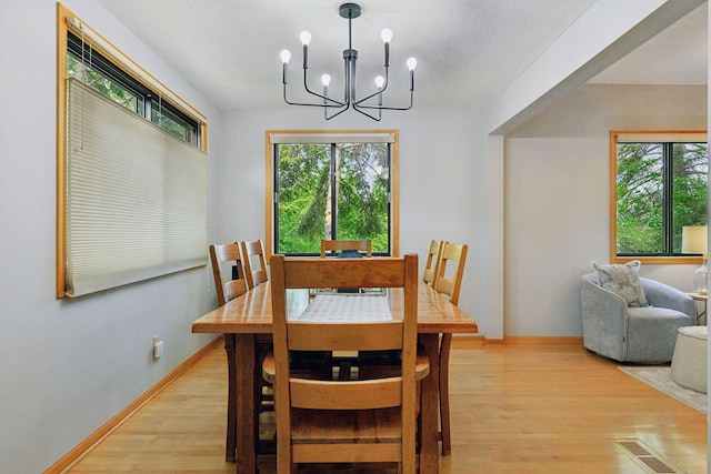 2452 Black Lake Rd, Spring Park, MN 55384 - dining space featuring light wood-style floors, plenty of natural light, and a chandelier
