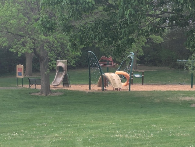 view of playground with a lawn