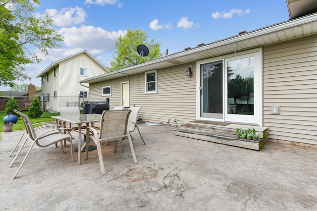 view of patio / terrace featuring outdoor dining area, fence, and entry steps