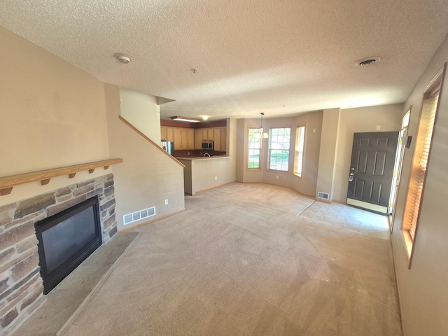 15437 Frost Path Unit 1507, Apple Valley, MN 55124 - unfurnished living room with a stone fireplace, a textured ceiling, light colored carpet, and baseboards