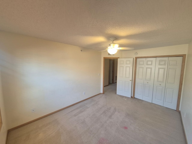 15437 Frost Path Unit 1507, Apple Valley, MN 55124 - unfurnished bedroom featuring a textured ceiling, light colored carpet, baseboards, a ceiling fan, and a closet