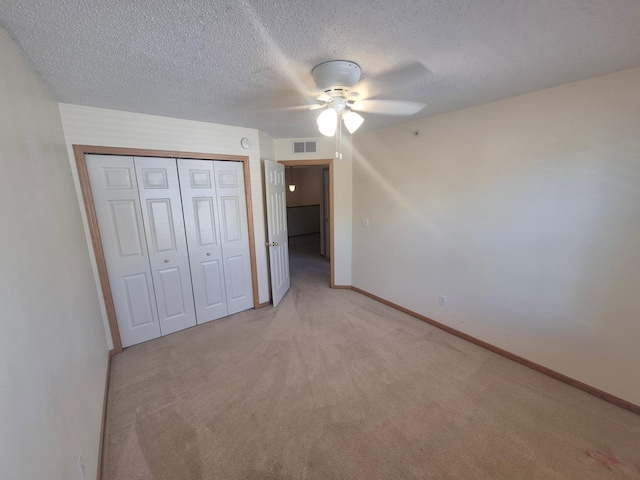 15437 Frost Path Unit 1507, Apple Valley, MN 55124 - unfurnished bedroom with light carpet, a closet, a textured ceiling, baseboards, and a ceiling fan