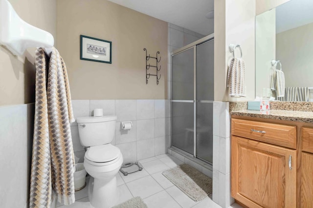 14464 Grouse Ln, Fifty Lakes, MN 56448 - full bathroom with vanity, a stall shower, tile patterned flooring, tile walls, and a wainscoted wall