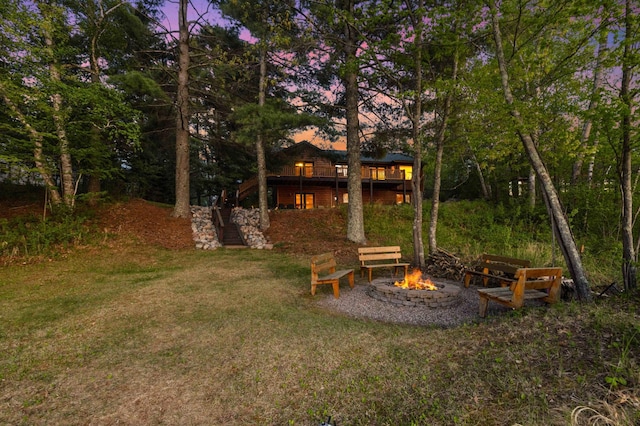 14464 Grouse Ln, Fifty Lakes, MN 56448 - view of grassy yard with a fire pit and stairway