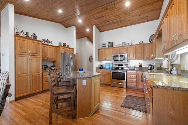 14464 Grouse Ln, Fifty Lakes, MN 56448 - kitchen with stainless steel appliances, wood ceiling, stone counters, a center island, and light wood-type flooring