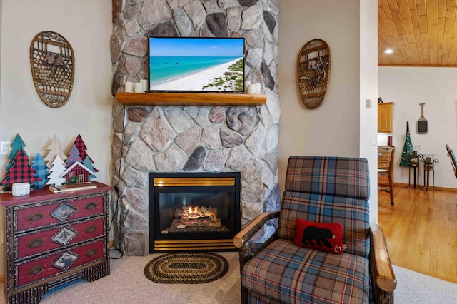 14464 Grouse Ln, Fifty Lakes, MN 56448 - living area featuring wood ceiling, a stone fireplace, and wood finished floors