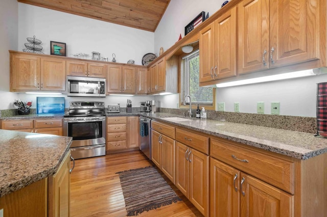 14464 Grouse Ln, Fifty Lakes, MN 56448 - kitchen with appliances with stainless steel finishes, light wood finished floors, wooden ceiling, vaulted ceiling, and light stone countertops