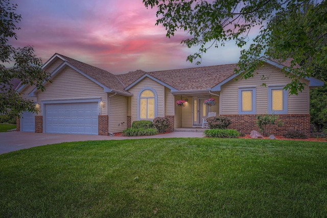 13546 Maryland Ave, Savage, MN 55378 - single story home with brick siding, a yard, an attached garage, and driveway