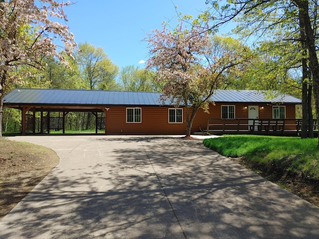 3245 Laketown Rd, Sturgeon Lake, MN 55783 - view of front of home featuring driveway, an attached carport, metal roof, and a standing seam roof