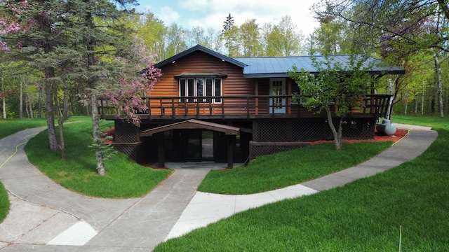 3245 Laketown Rd, Sturgeon Lake, MN 55783 - view of front of home featuring a front lawn, a wooden deck, metal roof, and driveway