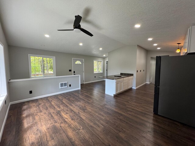 3245 Laketown Rd, Sturgeon Lake, MN 55783 - unfurnished living room with a ceiling fan, dark wood finished floors, vaulted ceiling, baseboards, and recessed lighting