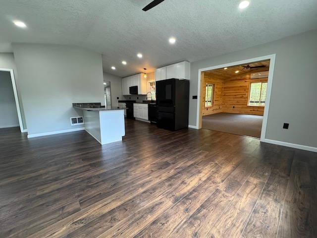 3245 Laketown Rd, Sturgeon Lake, MN 55783 - kitchen with ceiling fan, dark countertops, open floor plan, black fridge, and vaulted ceiling
