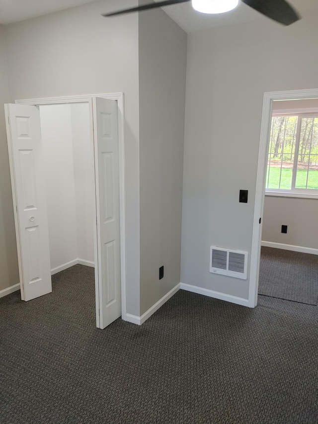 3245 Laketown Rd, Sturgeon Lake, MN 55783 - unfurnished room featuring dark carpet, baseboards, and a ceiling fan