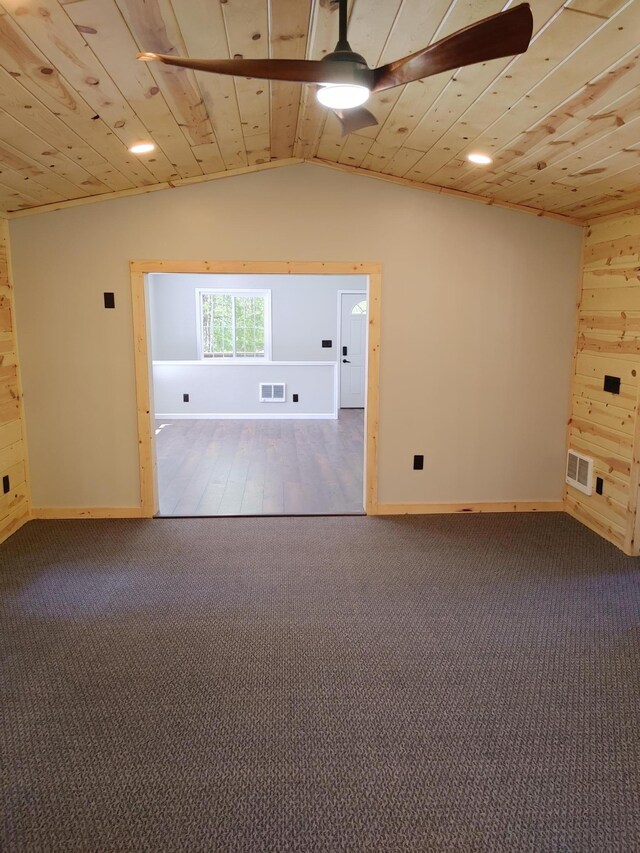 3245 Laketown Rd, Sturgeon Lake, MN 55783 - unfurnished room featuring ceiling fan, carpet, lofted ceiling, wood walls, and baseboards