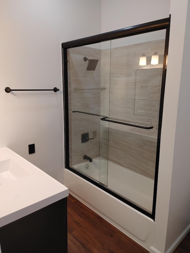 3245 Laketown Rd, Sturgeon Lake, MN 55783 - bathroom with vanity, bath / shower combo with glass door, and wood finished floors