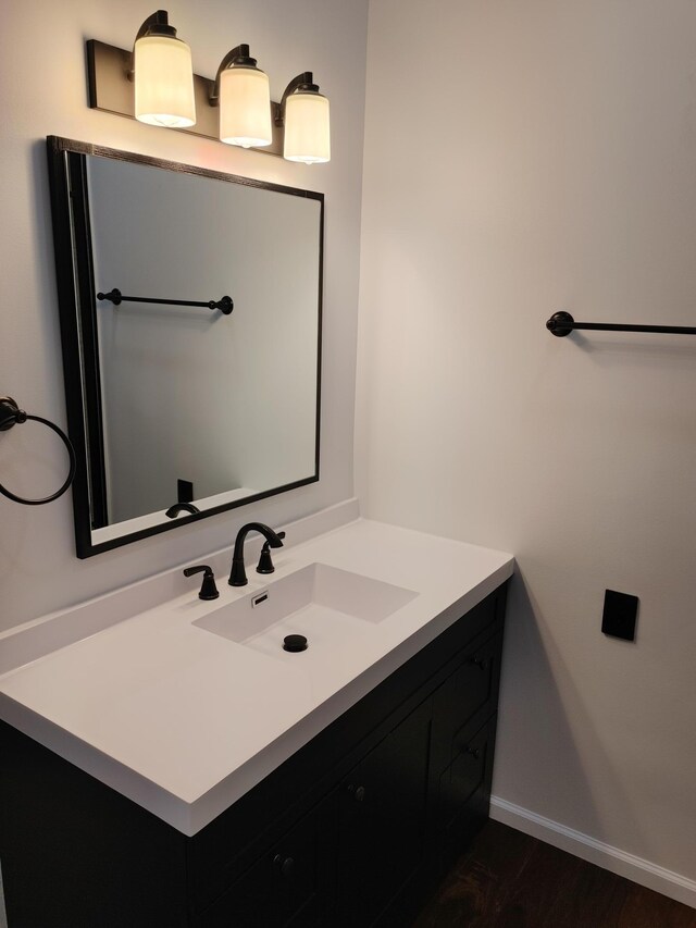 3245 Laketown Rd, Sturgeon Lake, MN 55783 - bathroom featuring vanity, wood finished floors, and baseboards