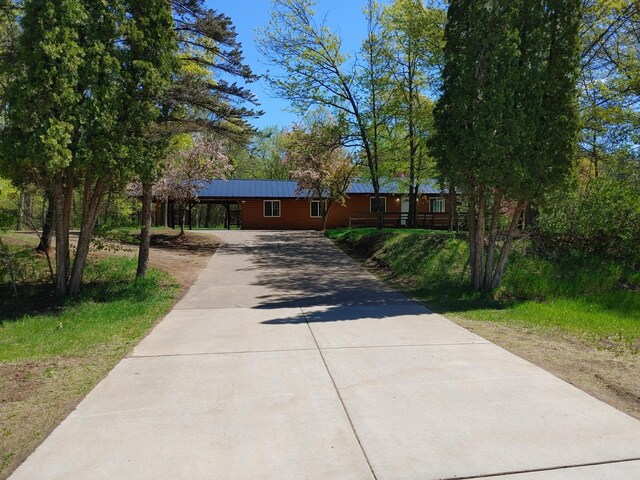 3245 Laketown Rd, Sturgeon Lake, MN 55783 - view of front facade featuring concrete driveway and metal roof