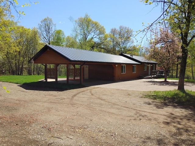 3245 Laketown Rd, Sturgeon Lake, MN 55783 - view of side of property featuring a carport, driveway, and metal roof