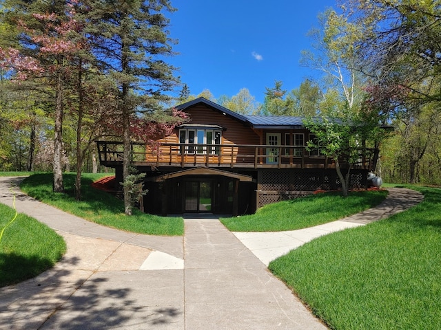 3245 Laketown Rd, Sturgeon Lake, MN 55783 - view of front of house with french doors, a wooden deck, a front yard, and metal roof
