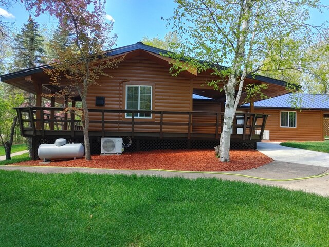 3245 Laketown Rd, Sturgeon Lake, MN 55783 - rear view of house featuring a cooling unit, log veneer siding, and a lawn