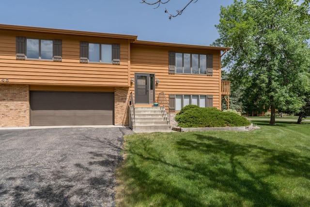 45 Restless Ct Unit 101, North Mankato, MN 56003 - bi-level home with a garage, a front yard, brick siding, and asphalt driveway